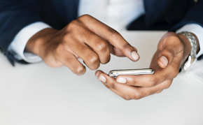A person tapping on their smartphone.